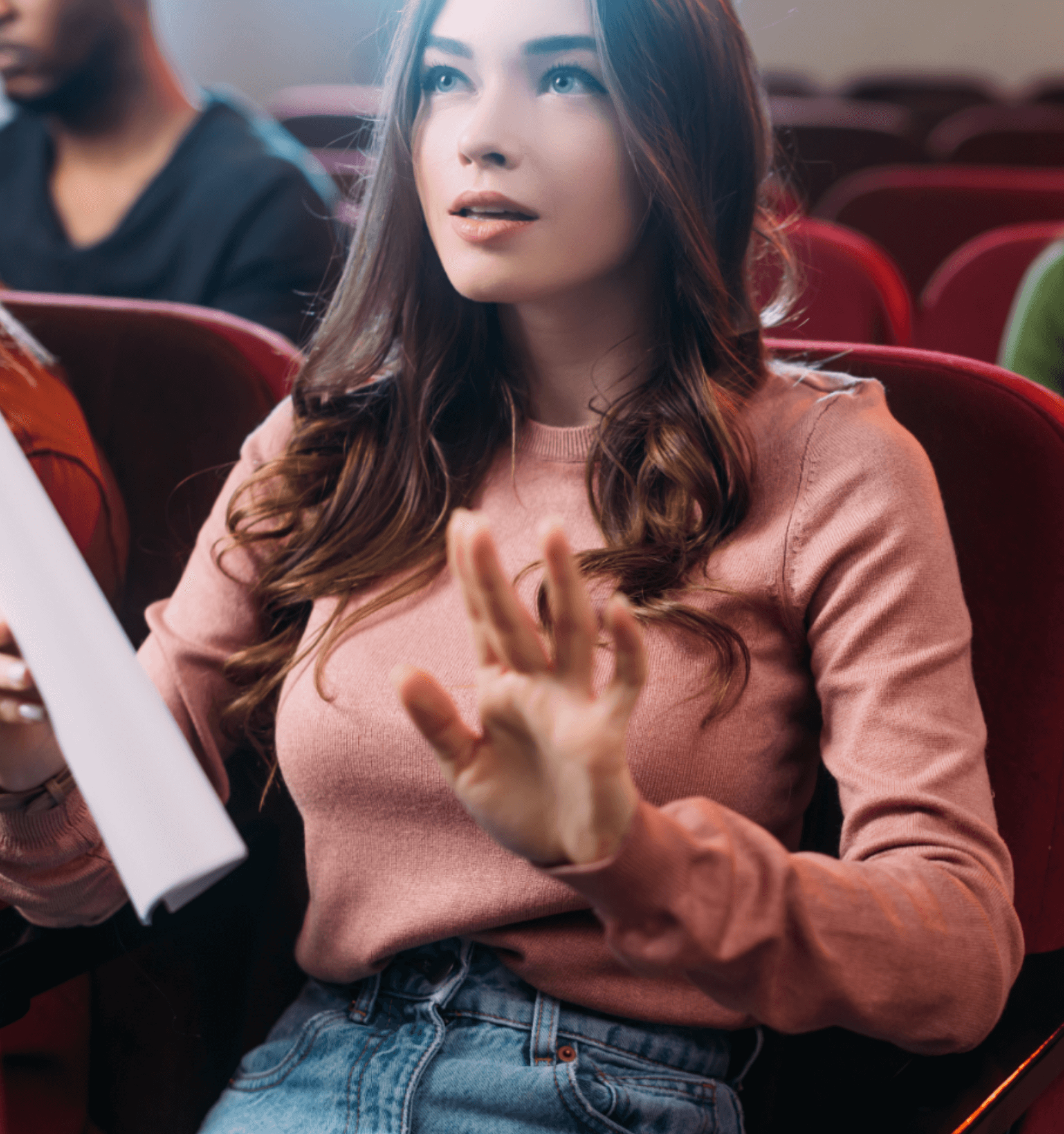 young woman in rose colored sweater ready to audtion